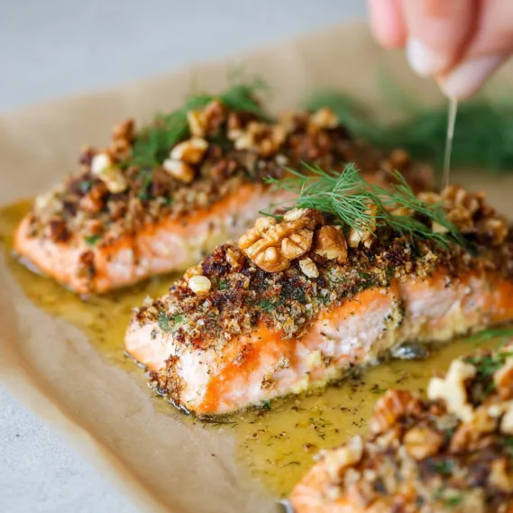 A plate of salmon with a mustard and dill sauce.