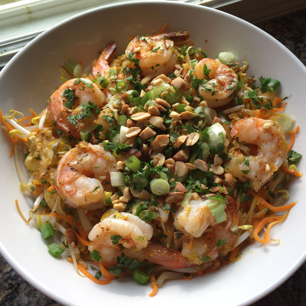 A bowl of shrimp and vegetables.