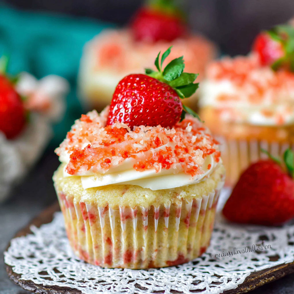 A cupcake with a strawberry on top.
