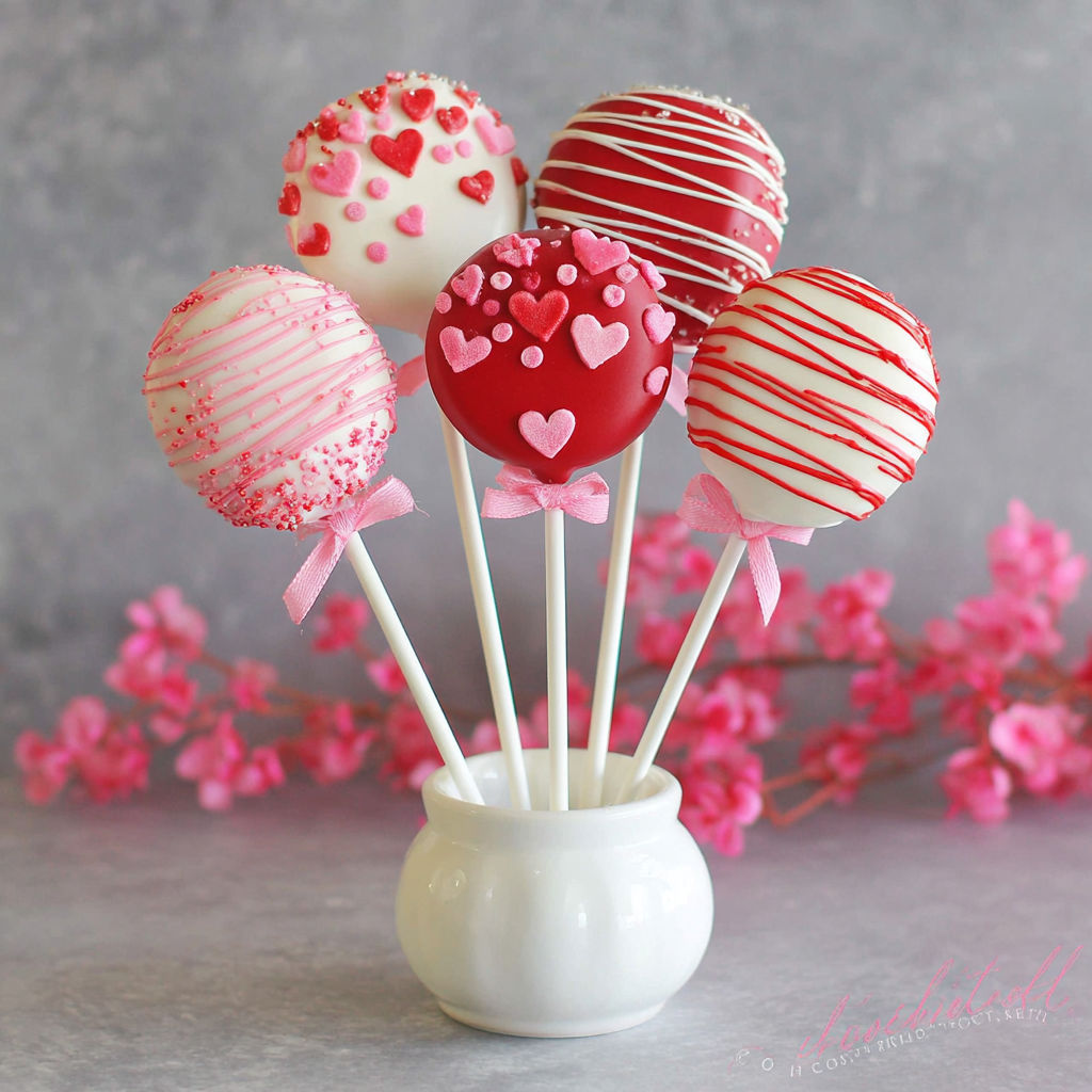 A white bowl with red and white heart shaped candy.