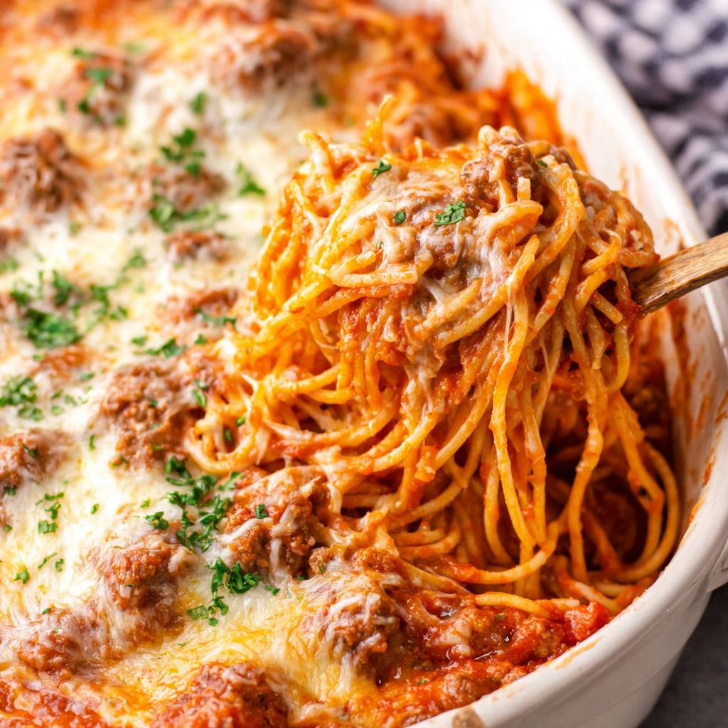 A close up of a spaghetti dish with meat and cheese.