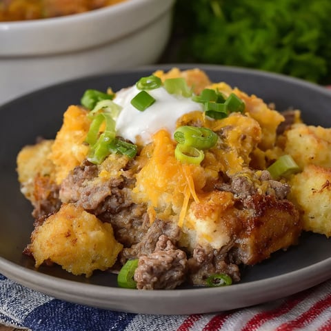 A plate of food with a white sauce on top.