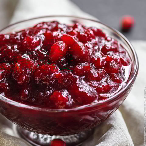 A glass bowl of cranberry sauce.