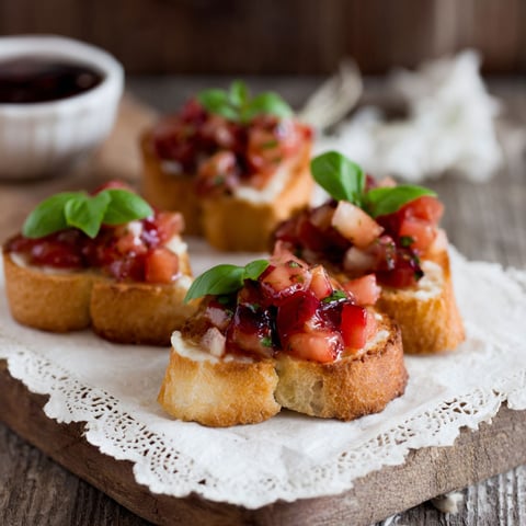A plate of food with tomatoes and basil.